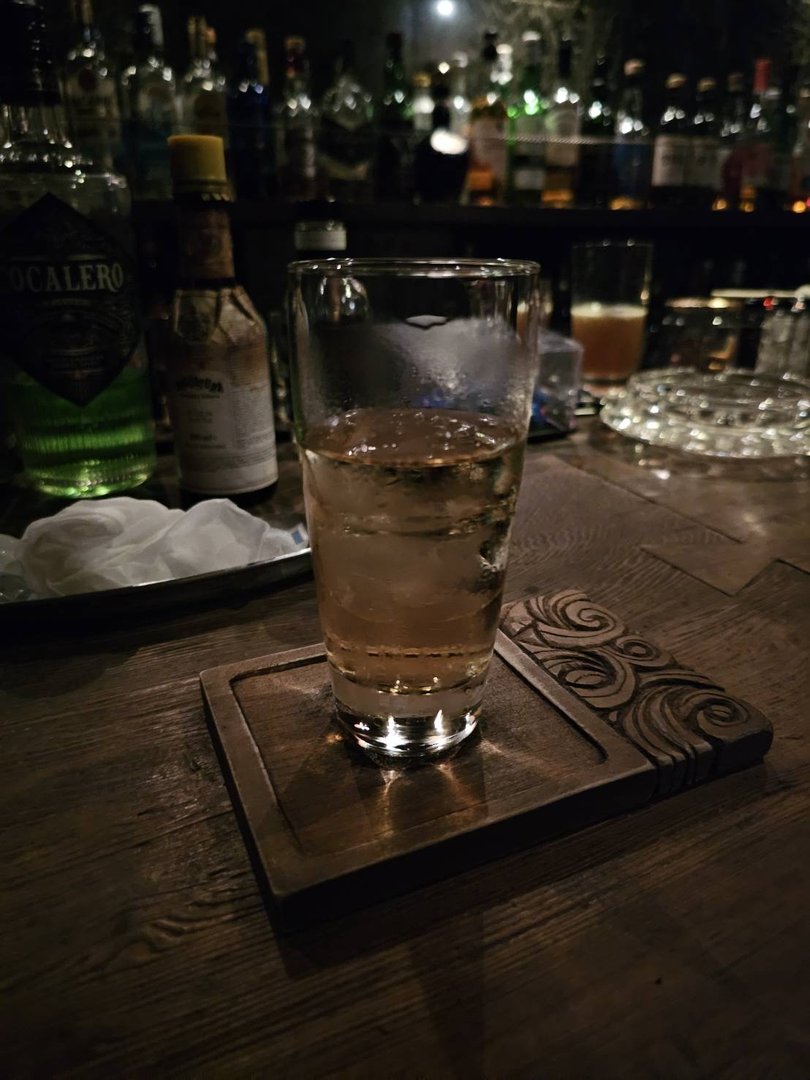 A tall drink photographed at a bar